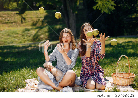 Elegant and stylish girls in a spring park Elegant and stylish girls in a spring park 59763028
