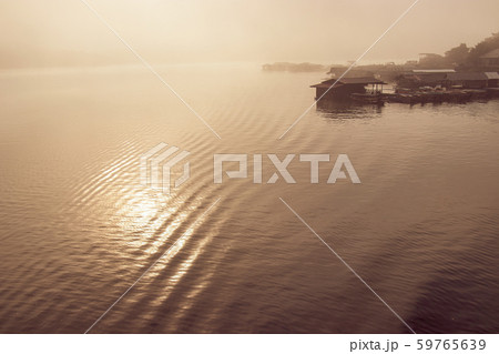blurred scene of raft Huts on a river in the morning fog at Sangkhlaburi, Kanchanauri, Thailand 59765639