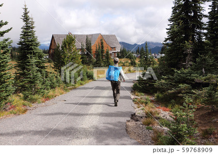 Man walking down a mountain trail near Mt.Rainier 59768909