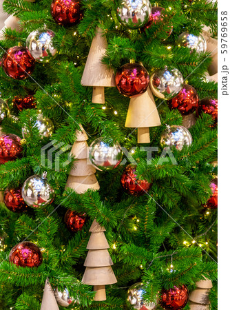 Christmas tree with silver bauble ornaments. Decorated Christmas tree closeup. Balls and illuminated Christmas tree with silver bauble ornaments. Decorated Christmas tree closeup. Balls and illuminated 59769658