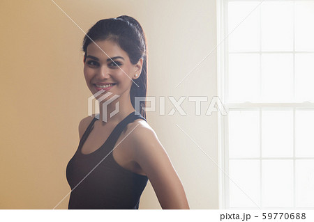 Portrait of a smiling young woman in workout clothes. Portrait of a smiling young woman in workout clothes. 59770688