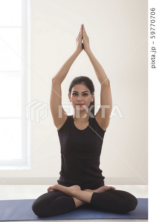 Close up of young fitness woman doing yoga sitting on yoga mat. 59770706