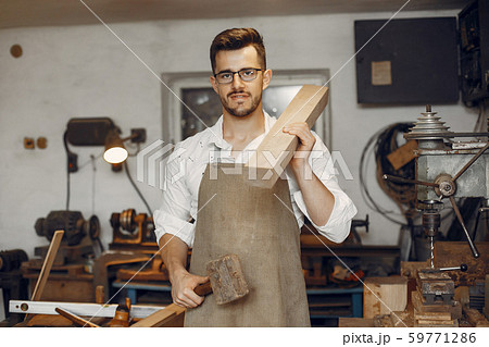 Handsome carpenter working with a wood 59771286