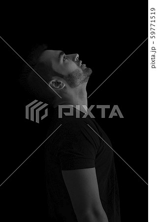 portrait of man while looking up Against Black Background portrait of man while looking up Against Black Background 59771519