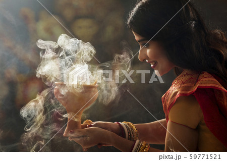 Bengali Married woman doing a Dhunuchi dance on the occasion of durga puja Bengali Married woman doing a Dhunuchi dance on the occasion of durga puja 59771521