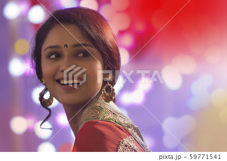 Portrait Of A Woman In Saree With Diwali Lights Bokeh In Background Portrait Of A Woman In Saree With Diwali Lights Bokeh In Background 59771541