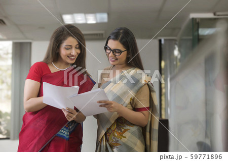 woman standing with reports in hand 59771896