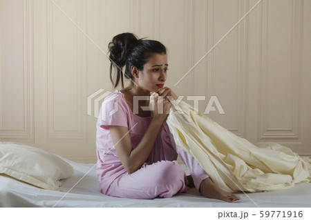 Young girl sitting alone in distress Young girl sitting alone in distress 59771916