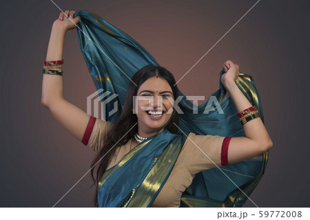 young woman dancing in saree 59772008