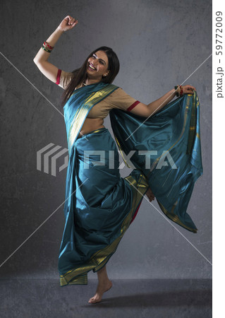young woman dancing in saree 59772009