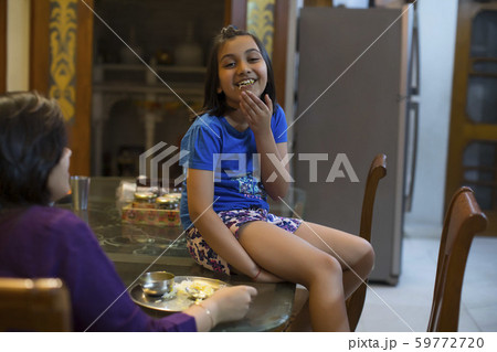 Mother-daughter having fun while eating 59772720