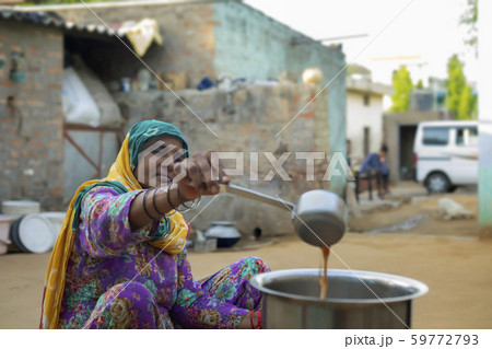 woman making tea in a big pan woman making tea in a big pan 59772793