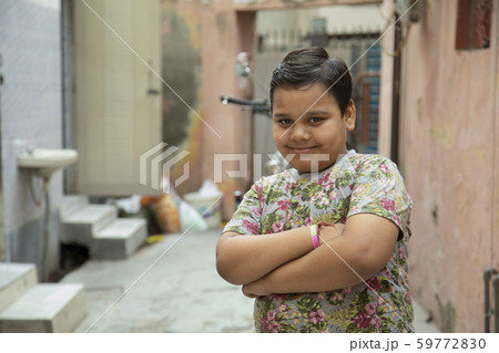 portrait ofa young boy standing in the varandah 59772830