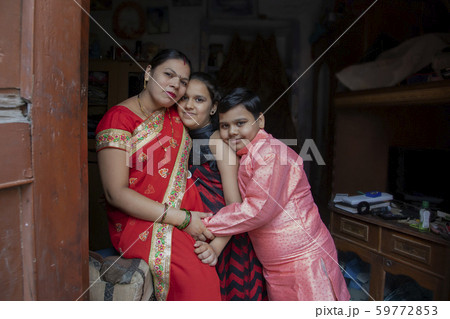mother sitting with her children 59772853