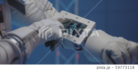 Astronaut using wrist computer 59773118