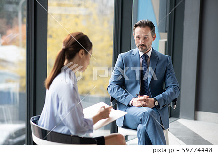 Young journalist speaking with businessman about his success story Young journalist speaking with businessman about his success story 59774448