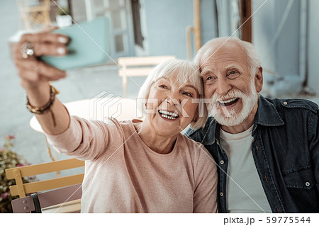 Happy aged couple taking a selfie together 59775544