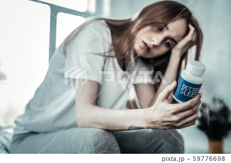 Selective focus of sleeping pills in female hand Selective focus of sleeping pills in female hand 59776698