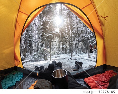 Camping with hand holding cup in yellow tent with 59778185