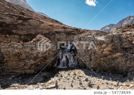 Cliff rock with waterfall flowing in stream 59778699