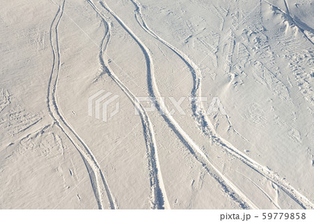 Snowy abstract off-piste skiing backround with ski and snowboard trails and tracks on new virgin Snowy abstract off-piste skiing backround with ski and snowboard trails and tracks on new virgin 59779858