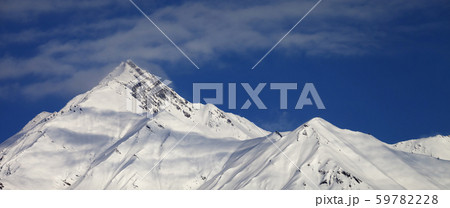 Snowy slope and blue sky with clouds at sunny 59782228