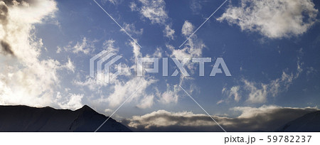 Blue sky with clouds and mountains in evening 59782237