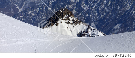 Trace from ski and snowboards on off-piste slope 59782240