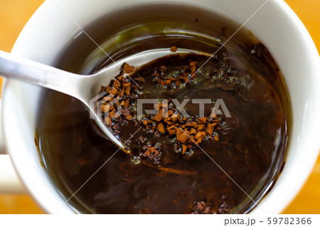 Spoon of Instant coffee granules pour in cup of coffee, Wooden background, Close up & Macro shot, Selective focus, Relax time, Drink concept 59782366