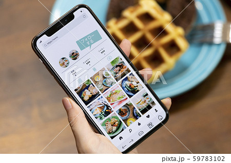 スマートフォンでSNSを見る女性の手元 スマートフォンでSNSを見る女性の手元 59783102