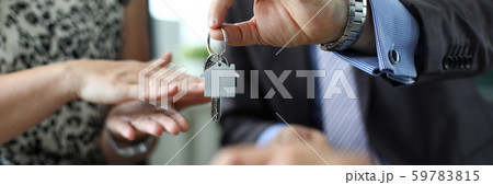 Man giving keys to new house owner 59783815