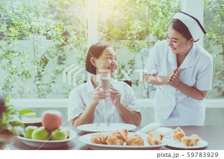 Senior asian woman hands holding a glass of water and nurse take care,Elderly healthy food concept 59783929
