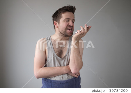 Angry untidy man giving voice command Angry untidy man giving voice command 59784200