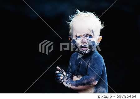 Happy dirty child having fun on black sand beach Happy dirty child having fun on black sand beach 59785464