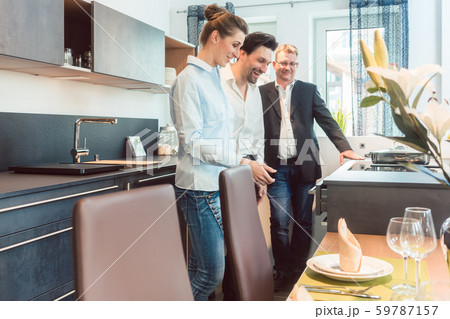 Woman and man shopping for a kitchen and other furniture 59787157