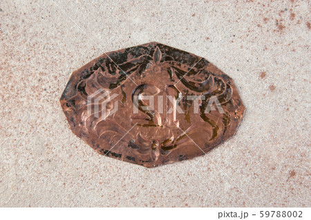 Antique copper door number on concrete background 59788002