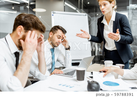 Boss quarreling at employees during a conference Boss quarreling at employees during a conference 59788391