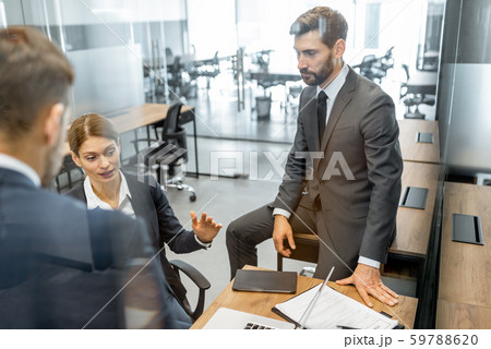Business people during a discussion at the working place Business people during a discussion at the working place 59788620