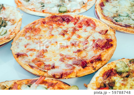 Pizza with Mozzarella cheese, salami, Tomatoes, pepper, Spices. Italian pizza Pizza with Mozzarella cheese, salami, Tomatoes, pepper, Spices. Italian pizza 59788748