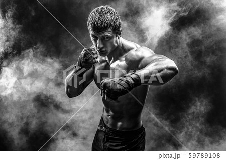 Handsome topless sportsman practicing punches 59789108