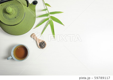 Tea time concept. Green iron teapot, cup of tea Tea time concept. Green iron teapot, cup of tea 59789117