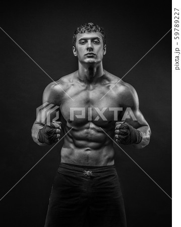 Handsome topless muscular man in fighting gloves Handsome topless muscular man in fighting gloves 59789227