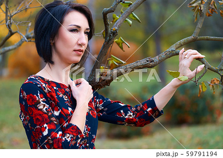 Beautiful elegant woman standing and posing near Beautiful elegant woman standing and posing near 59791194