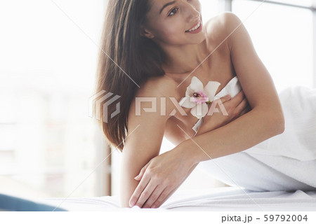 Beautiful body woman with white flower orchid and body care. Beautiful body woman with white flower orchid and body care. 59792004