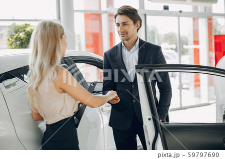 Stylish and elegant couple in a car salon 59797690