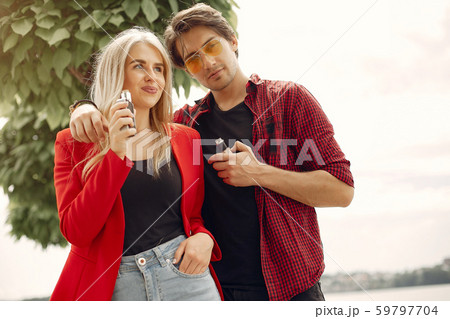 Stylish young couple with vape in a city 59797704