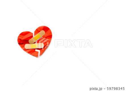 Broken red heart symbol with medical patch on white background, love concept. healing 59798345