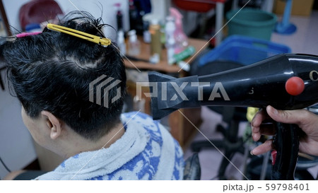 Hairdressers are using hair dryers for customers after washing their hair. 59798401