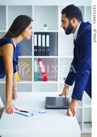 Portrait of angry people looking at each other during conflict Portrait of angry people looking at each other during conflict 59805261