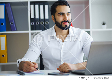 Man working in office in front of desktop computer Man working in office in front of desktop computer 59805308
